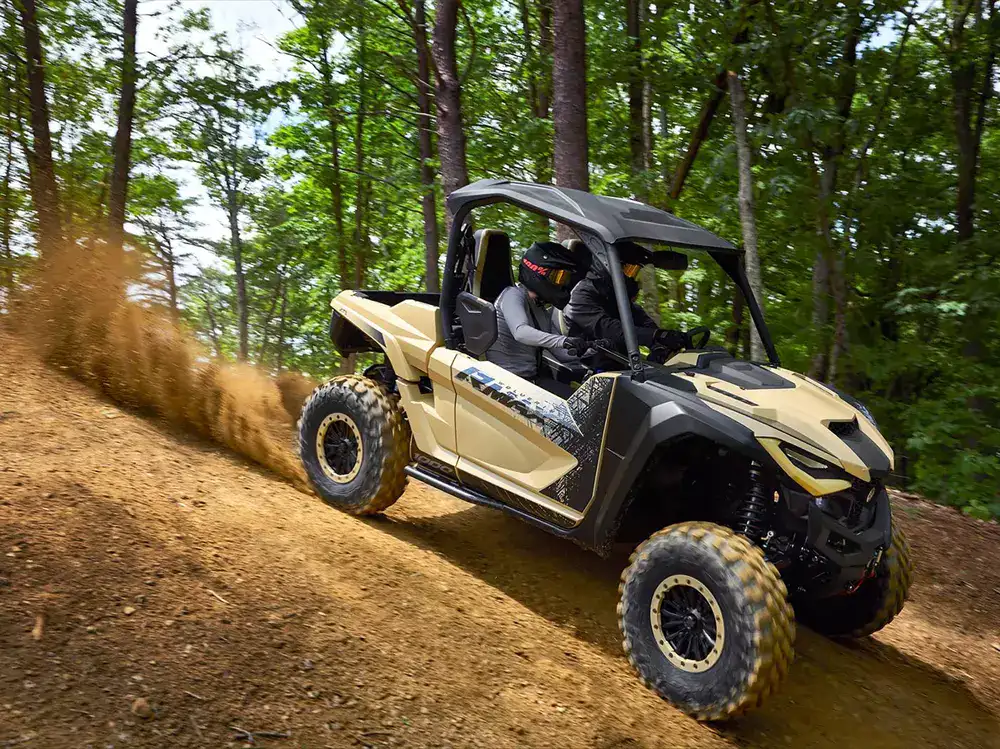 Yamaha Wolverine RMAX2 1000 off-road vehicle driving through rugged terrain